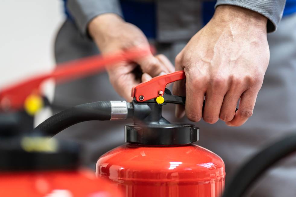 man trying to use fire extinguisher