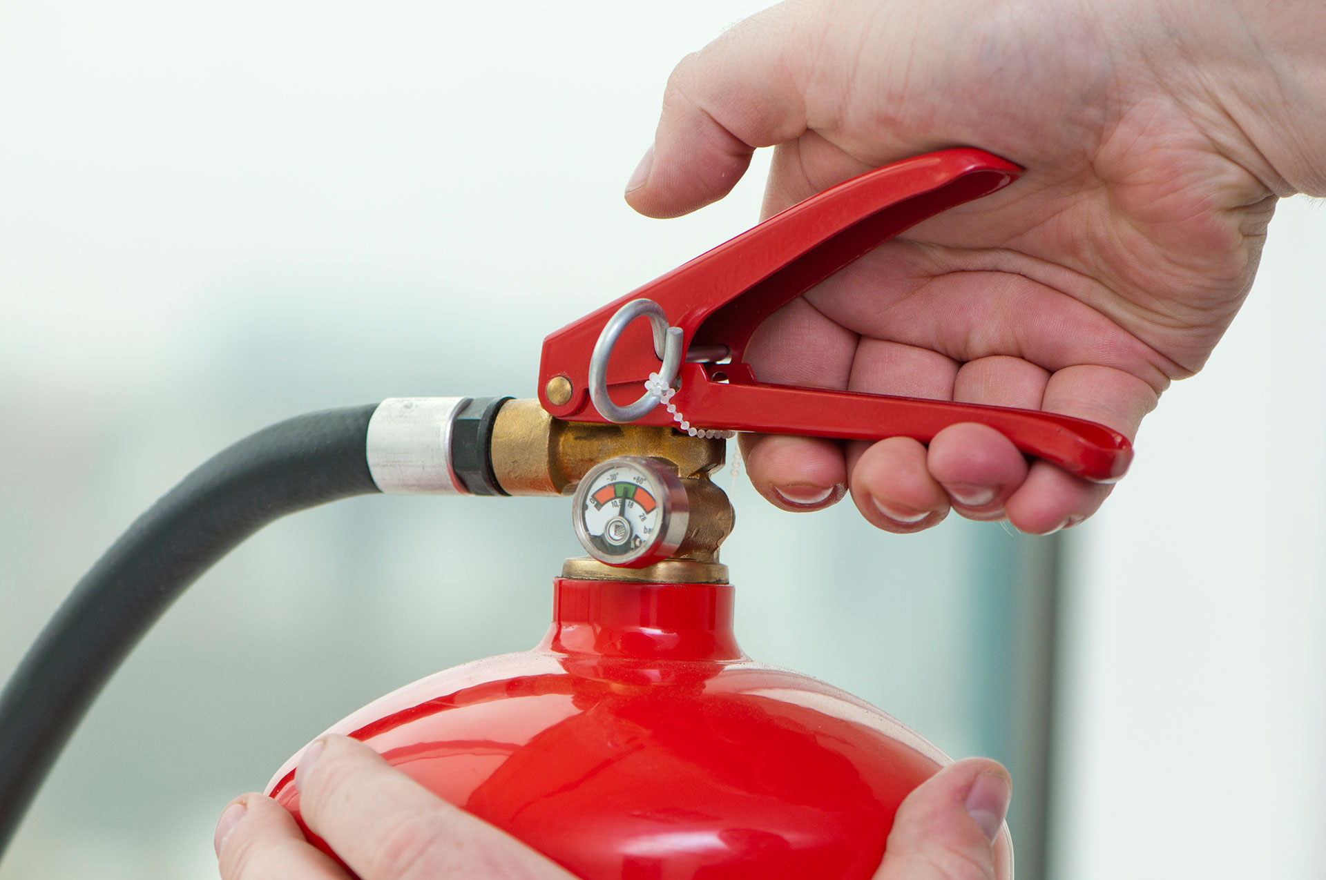 Hand Pressing Fire Extinguisher